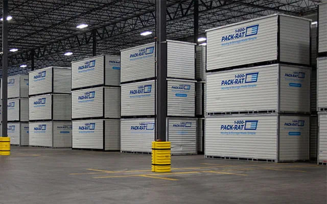 A view of the inside of a 1-800-PACK-RAT storage facility with multiple 16-foot containers with customer belongings securely stacked on top of each other